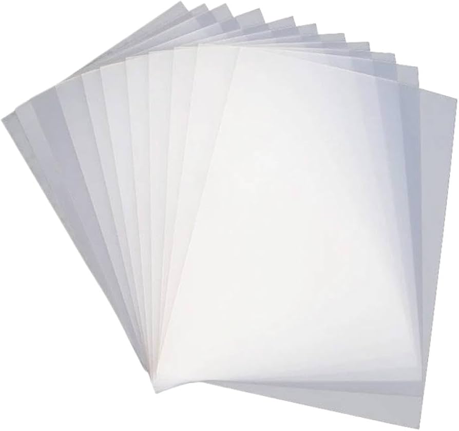 A pack of 100 American DTF Supply A3 instant peel DTF transfer sheets, 12x16 inches, spread out flat for printing.