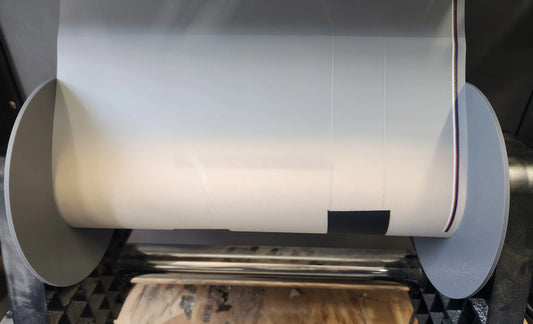 American DTF Supply film take-up guide showing a durable plastic roller and guide for proper film alignment.